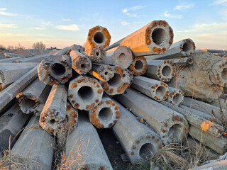 Old concrete lighting poles at junkyard