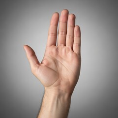 A single hand raised vertically with palm displayed against a grey gradient, suggesting a signal, stop, or positive affirmation.