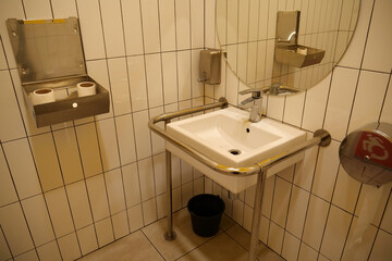 Toilet for people with disabilities. Sink with special grab bars