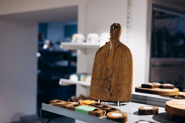 Wooden cutting board on store shelf for gift idea, copy space.