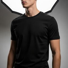 Man models a classic black t-shirt in a professional studio setting with dramatic lighting