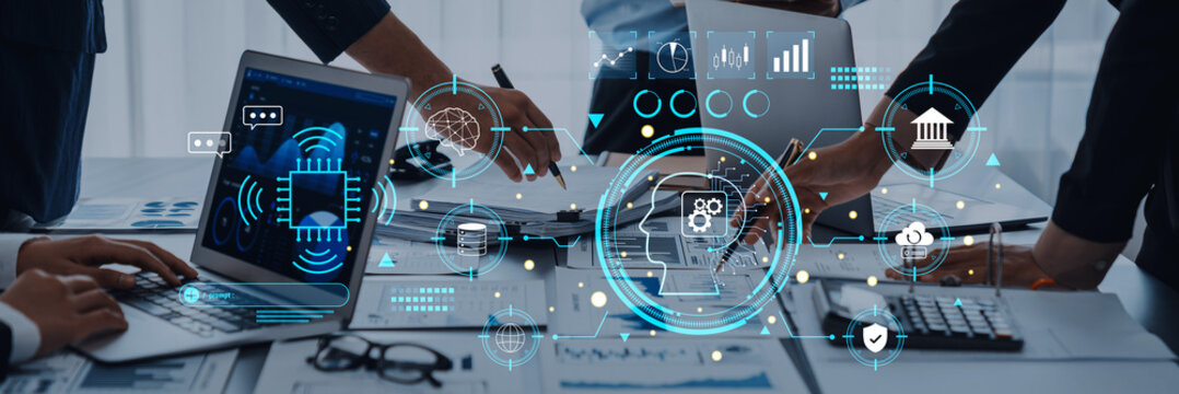 A group of professionals engage in a modern business meeting, utilizing laptops and technology interfaces to enhance collaboration and data analysis for informed decision-making. Trope - Powered by Adobe