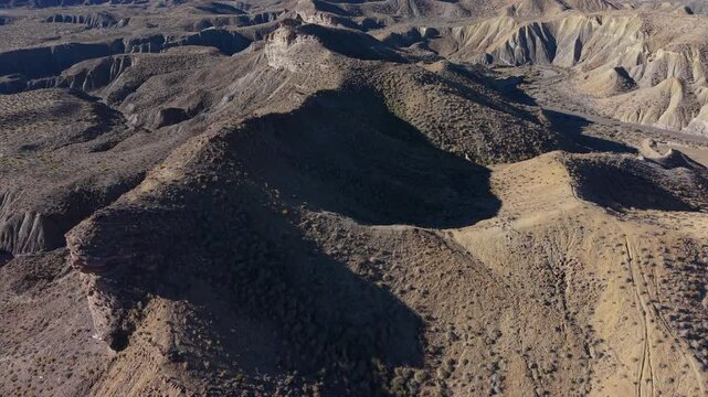 Drone view revealing the arid badlands and mountains of the Tabernas Desert in Almeria, Spain
