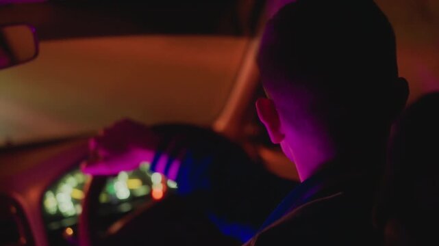 Rear view driver in neon glow, steering through empty avenues with dashboard lights and gentle bokeh late night courier atmosphere, calm pacing and reflective mood captured in warm amber and purple