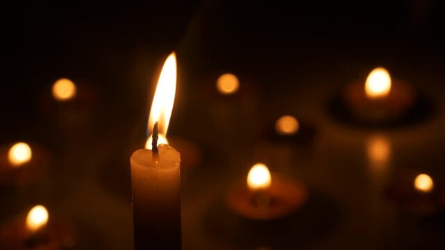Candlelight Vigil - Single Candle Flame with Blurred Lights