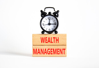 Wealth Management symbol. Concept words Wealth Management on wooden blocks. Beautiful white background with alarm clock. Business and Wealth Management concept. Copy space