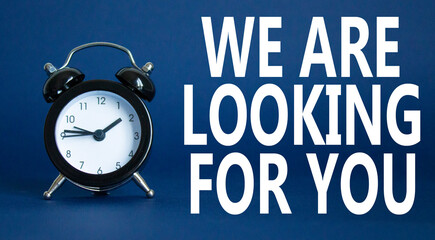 Tell us what you think symbol. Wooden blocks with words Tell us what you think. Beautiful deep blue background with alarm clock. Business and Tell us what you think concept. Copy space.