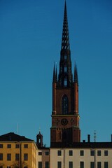 Fototapeta premium Riddarholmen Church Spire Against Clear Blue Sky in Stockholm