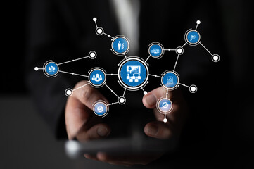 A close-up of a hand holding a smartphone with networking and data visualization icons illustrating business growth and digital strategy concepts on a dark background. Tessel