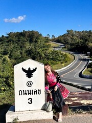 Elegant Woman in Traditional Hmong Dress Standing on the Scenic Number 3 Road in Nan, Thailand