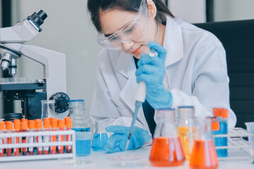 Portrait, science and happy woman on laptop in lab to research chemistry, test or innovation. Microscope, scientist and face of medical doctor in goggles for microbiology, healthcare or pharma study
