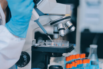 Portrait, science and happy woman on laptop in lab to research chemistry, test or innovation. Microscope, scientist and face of medical doctor in goggles for microbiology, healthcare or pharma study