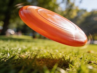 A frisbee is flying through the air in a grassy field