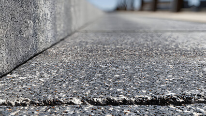 Ultra-realistic image of concrete worker smoothing driveway edges near garage entrance