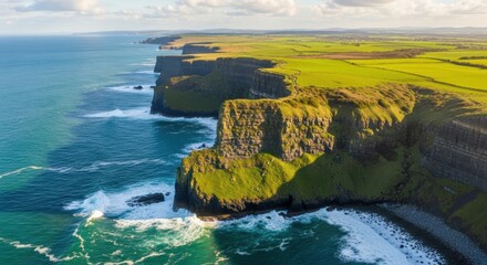 Aerial view of the cliffs of moher with green fields and crashing ocean waves