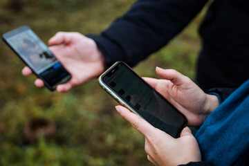 two individuals compare fungus images using smartphones for precise identification and examination