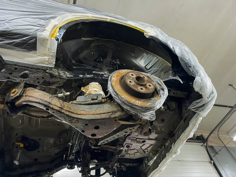 rust repair scene, structural repair and rust removal in automotive workshop setting, scene depicting engine bay overhaul with emphasis on corrosion elimination and structural reinforcement