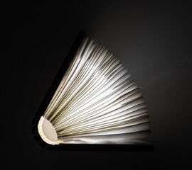 light from a magic book on a black background