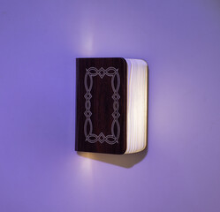 light from a magic book on a black background