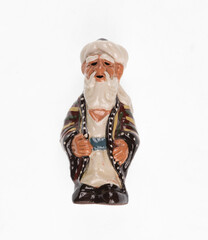 Ceramic figurine of an old Uzbek man isolated on white background