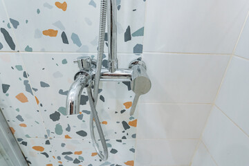 luxurious bathroom fixtures, modern chrome faucet setup, highend bathroom control devices with glass reflection, contemporary terrazzo tile with stylish plumbing and mirror reflection