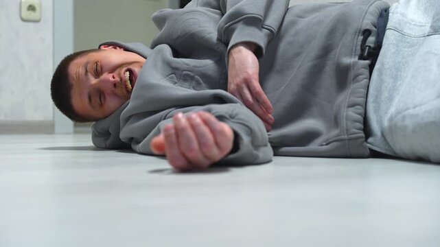 A man fell to the floor after a sudden heart attack.
Health problems for the man lying on the floor.
Falling to the floor and hitting his head.
A man recovering from a heart attack.
Fall, floor, man, 