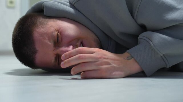 A man fell to the floor after a sudden heart attack.
Health problems for the man lying on the floor.
Falling to the floor and hitting his head.
A man recovering from a heart attack.
Fall, floor, man, 