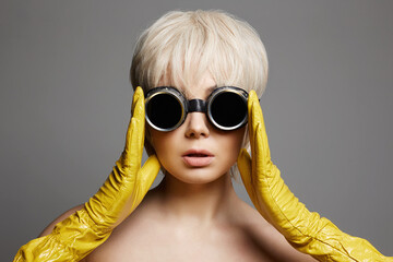  beautiful blonde hair woman in gloves and sunglasses. short hairstyle Girl