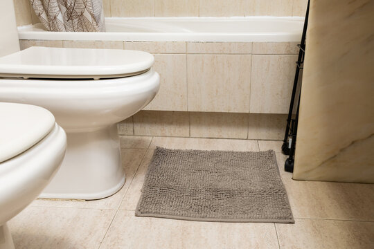Toilet and bidet in modern clean bathroom interior