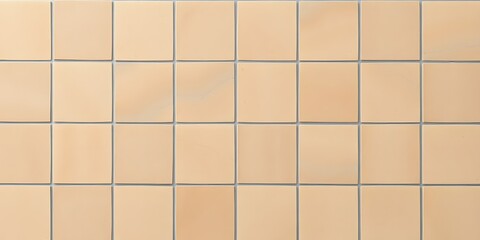 A high-angle view of a grid pattern of beige square tiles with subtle shading variations