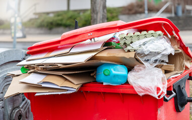 Waste container full of paper and plastic