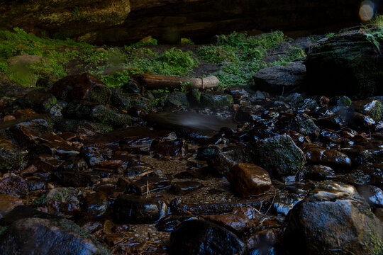 Castroviejo cave stream flowing through mossy rocks