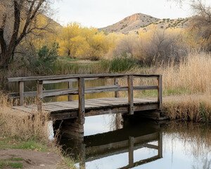 small wooden bridge in the autumn mountains and river background