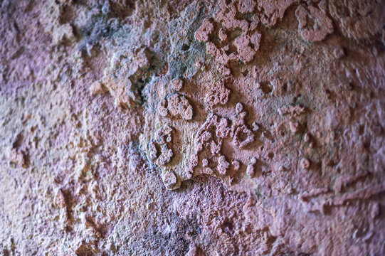 Close-up of rough textured old red brick surface