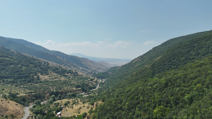 Aerial landscape of forested hills under a cloudy sky