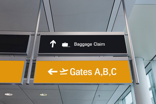Airport terminal direction signs. Baggage claim arrow above. Gates A B C sign below. Modern airport interior. Travel navigation system. Passenger wayfinding design. Clear transport information.