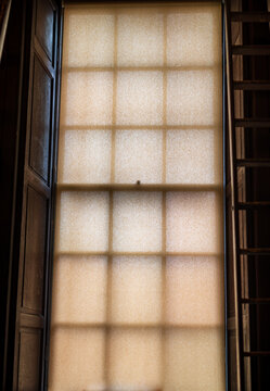 A tall window behind a transparent screen
