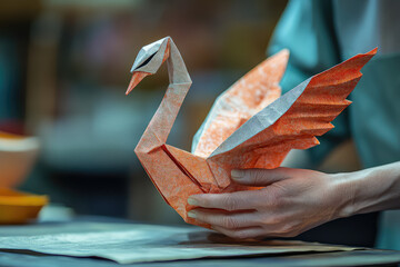 paper swan origami in human hands