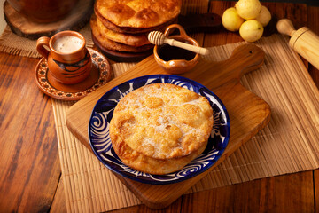 Bu&ntilde;uelos de rodilla. Traditional food at Christmas and winter holidays in Mexico, these are fried dough flour sprinkled with sugar or covered in a syrup made with piloncillo, cinnamon, and guava.