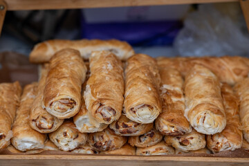 Golden pastry display, Decorative presentation of freshly baked golden rolls with visible filling textures