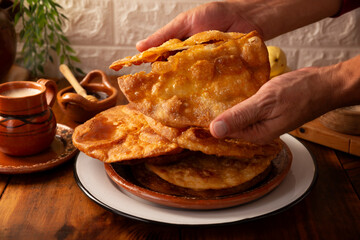 Bu&ntilde;uelos de rodilla. Traditional food at Christmas and winter holidays in Mexico, these are fried dough flour sprinkled with sugar or covered in a syrup made with piloncillo, cinnamon, and guava.
