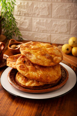Bu&ntilde;uelos de rodilla. Traditional food at Christmas and winter holidays in Mexico, these are fried dough flour sprinkled with sugar or covered in a syrup made with piloncillo, cinnamon, and guava.