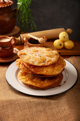 Bu&ntilde;uelos de rodilla. Traditional food at Christmas and winter holidays in Mexico, these are fried dough flour sprinkled with sugar or covered in a syrup made with piloncillo, cinnamon, and guava.