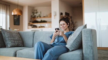 Healthcare professional reviewing patient data on a smartphone app illustrating appbased communication in a cozy home setting.