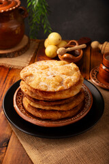 Bu&ntilde;uelos de rodilla. Traditional food at Christmas and winter holidays in Mexico, these are fried dough flour sprinkled with sugar or covered in a syrup made with piloncillo, cinnamon, and guava.