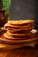 Bu&ntilde;uelos de rodilla. Traditional food at Christmas and winter holidays in Mexico, these are fried dough flour sprinkled with sugar or covered in a syrup made with piloncillo, cinnamon, and guava.