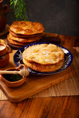 Bu&ntilde;uelos de rodilla. Traditional food at Christmas and winter holidays in Mexico, these are fried dough flour sprinkled with sugar or covered in a syrup made with piloncillo, cinnamon, and guava.