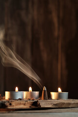 Candles and Incense Produce Smoke in a Simple Indoor Setting