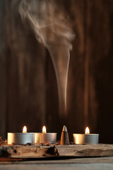 Candles and Incense Produce Smoke in a Simple Indoor Setting