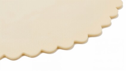 Raw scalloped pastry dough closeup isolated on white background for baking and cooking projects